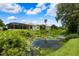 A serene backyard with a lake view and lush green landscape at 5904 Pelican Bay S Plz, Gulfport, FL 33707