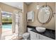 Bathroom featuring a modern vanity with a vessel sink, a shower, and access to an outdoor pool area at 5904 Pelican Bay S Plz, Gulfport, FL 33707