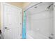 Bathroom featuring a bathtub with blue shower curtain and white tiled walls at 5904 Pelican Bay S Plz, Gulfport, FL 33707