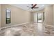 Spacious bedroom features beautiful stone floors, large windows, and a ceiling fan at 5904 Pelican Bay S Plz, Gulfport, FL 33707