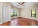This spacious bedroom features hardwood floors, large windows, and a closet at 5904 Pelican Bay S Plz, Gulfport, FL 33707