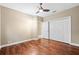 Bedroom featuring hardwood floors, a ceiling fan, and a double door closet for ample storage at 5904 Pelican Bay S Plz, Gulfport, FL 33707