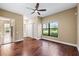 Bedroom features hardwood floors, large windows, ceiling fan, and closet at 5904 Pelican Bay S Plz, Gulfport, FL 33707