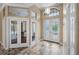 Inviting foyer with decorative doors, travertine floors, and transom windows for lots of natural light at 5904 Pelican Bay S Plz, Gulfport, FL 33707