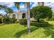 Beautifully landscaped front yard with mature trees and manicured shrubbery at 5904 Pelican Bay S Plz, Gulfport, FL 33707