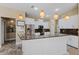 Bright kitchen with white cabinets, granite counters, and stainless steel appliances perfect for entertaining at 5904 Pelican Bay S Plz, Gulfport, FL 33707