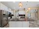 Bright kitchen with white cabinets, granite counters, and stainless steel appliances perfect for entertaining at 5904 Pelican Bay S Plz, Gulfport, FL 33707