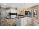 Bright kitchen with white cabinets, granite counters, and stainless steel appliances perfect for entertaining at 5904 Pelican Bay S Plz, Gulfport, FL 33707