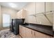 Bright laundry room with modern appliances, a sink, countertops, and ample cabinet space at 5904 Pelican Bay S Plz, Gulfport, FL 33707