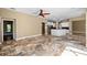 Expansive open concept with ceramic floors, ceiling fan, neutral walls and updated stainless appliances at 5904 Pelican Bay S Plz, Gulfport, FL 33707