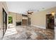 Large living room with tile floor, a fireplace, and multiple windows with view of the backyard at 5904 Pelican Bay S Plz, Gulfport, FL 33707