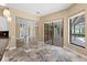Bright living room features beautiful stone floors and pool views through sliding glass doors at 5904 Pelican Bay S Plz, Gulfport, FL 33707