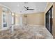 A spacious living room with tile floors, ceiling fan, and lots of natural light at 5904 Pelican Bay S Plz, Gulfport, FL 33707