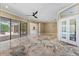 Spacious living room with travertine floors and access to the pool area through sliding glass doors at 5904 Pelican Bay S Plz, Gulfport, FL 33707