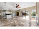 Great open floor plan with high ceilings, tile flooring, and access to outdoor living with a pool view at 5904 Pelican Bay S Plz, Gulfport, FL 33707