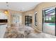 Bright living room features beautiful stone floors and pool views through sliding glass doors at 5904 Pelican Bay S Plz, Gulfport, FL 33707