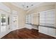 Home office boasting built-in shelves, cabinets, granite countertops, hardwood floors, and french doors at 5904 Pelican Bay S Plz, Gulfport, FL 33707