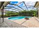 Screen enclosed pool with brick patio and cozy fire pit at 5904 Pelican Bay S Plz, Gulfport, FL 33707