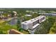 An aerial view showcasing the building and a serene lake with fountain at 5920 80Th N St # 406, St Petersburg, FL 33709