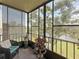 Screened balcony with relaxing chair and peaceful views of the pond and verdant surroundings at 5920 80Th N St # 406, St Petersburg, FL 33709