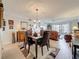 Inviting dining area featuring hardwood floors, chandelier, and access to the living room at 5920 80Th N St # 406, St Petersburg, FL 33709