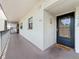 Welcoming entrance to unit 406 featuring a modern door with glass and a cozy welcome mat at 5920 80Th N St # 406, St Petersburg, FL 33709