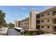 Multi-story building with balconies, flagpole and parking, ideal for convenient community living at 5920 80Th N St # 406, St Petersburg, FL 33709