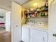 Convenient laundry closet with washer, dryer, and shelving for ample storage solutions at 5920 80Th N St # 406, St Petersburg, FL 33709