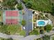 Aerial view of community amenities including a pool, tennis courts and parking area at 6336 Bayside Key Dr, Tampa, FL 33615
