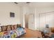 Bedroom featuring a colorful daybed, wood floors, and standard closet view at 6336 Bayside Key Dr, Tampa, FL 33615