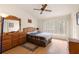 Bedroom featuring wood floors, ceiling fan and a large window for ample natural light at 6336 Bayside Key Dr, Tampa, FL 33615