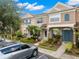 Charming townhome featuring colorful shutters, lush landscaping, and a welcoming entrance at 6336 Bayside Key Dr, Tampa, FL 33615