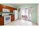 Bright kitchen featuring white appliances, tile floors, and sliding glass doors to the lanai at 6336 Bayside Key Dr, Tampa, FL 33615