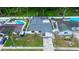 Aerial view of the property showcasing a well maintained front lawn, and an enclosed pool at 6460 101St N Ave, Pinellas Park, FL 33782