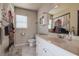 Bright bathroom featuring a single sink vanity, window, toilet, and tub-shower combo with a unique curtain at 6460 101St N Ave, Pinellas Park, FL 33782