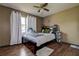 Comfortable bedroom features wood-look floors, neutral paint, and a window providing natural light at 6460 101St N Ave, Pinellas Park, FL 33782