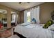 Comfortable bedroom with wood-look floors, neutral paint, and a large mirrored closet at 6460 101St N Ave, Pinellas Park, FL 33782