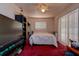Bedroom with red carpet, ceiling fan, window, sliding glass doors, and a neatly made bed at 6460 101St N Ave, Pinellas Park, FL 33782