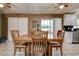 Cozy dining area with tile floors, a wooden table set, and natural light from a window at 6460 101St N Ave, Pinellas Park, FL 33782