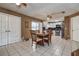 Bright dining area featuring tile flooring, a wooden table set, and a view of the kitchen at 6460 101St N Ave, Pinellas Park, FL 33782