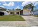 Welcoming single-story home with a well-maintained lawn, stone accents and attached garage at 6460 101St N Ave, Pinellas Park, FL 33782
