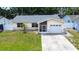Inviting one-story home with stone accents, green lawn and convenient attached garage at 6460 101St N Ave, Pinellas Park, FL 33782