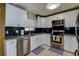 Well-lit kitchen features stainless steel appliances, granite counters, and black subway tile backsplash at 6460 101St N Ave, Pinellas Park, FL 33782