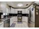 Well-lit kitchen features stainless steel appliances, granite counters, and white cabinetry at 6460 101St N Ave, Pinellas Park, FL 33782
