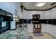 Well-lit kitchen features stainless steel appliances, granite counters, and black subway tile backsplash at 6460 101St N Ave, Pinellas Park, FL 33782