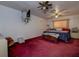 Cozy main bedroom with red carpet, ceiling fans, and a large window providing natural light at 6460 101St N Ave, Pinellas Park, FL 33782