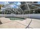 A partially covered swimming pool with a concrete deck and a fenced-in perimeter at 6460 101St N Ave, Pinellas Park, FL 33782