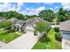 Aerial view of a charming single-story home with a well-manicured lawn and a three-car garage at 679 Challice Dr, Spring Hill, FL 34609