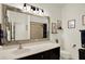 Charming bathroom features custom mirror, lighting, and tiled shower at 679 Challice Dr, Spring Hill, FL 34609