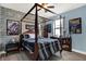 Unique bedroom featuring a four-poster bed, blue accent walls, and themed decor that creates an immersive atmosphere at 679 Challice Dr, Spring Hill, FL 34609
